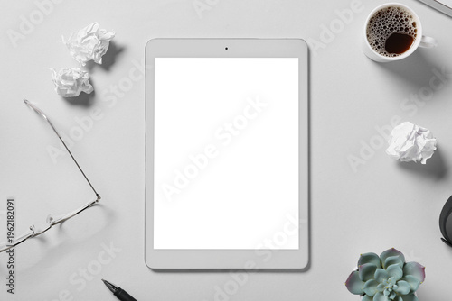 Tablet computer with cup of...