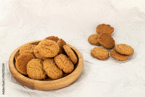Oatmeal cookies with kitchen utensils on kraft paper, close-up. Top view.