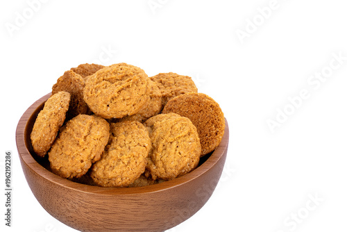 Oatmeal cookies with kitchen utensils isolated on white background, close-up.