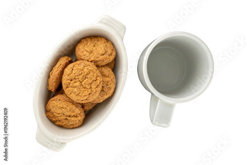 Oatmeal cookies with kitchen utensils isolated on white background, close-up.