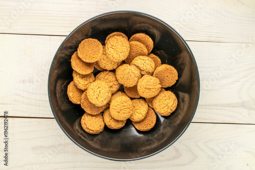 Oatmeal cookies with kitchen utensils on a wooden table, close-up. Top view.
