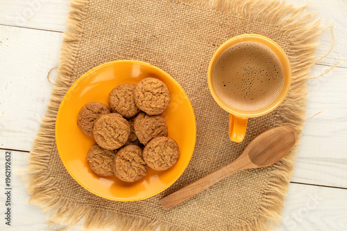 Oatmeal cookies with kitchen utensils on a wooden table, close-up. Top view.
