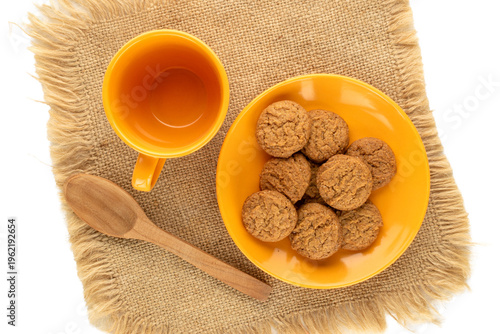 Oatmeal cookies with kitchen utensils on a jute napkin, close-up. Top view.