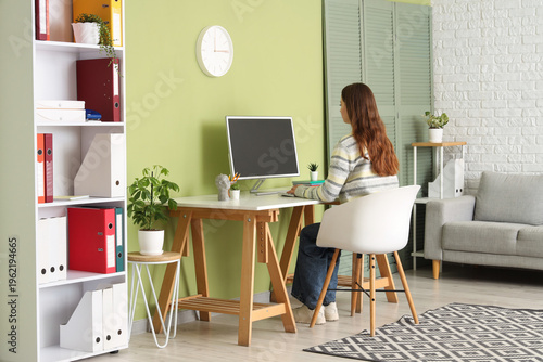 Young woman working at desk...