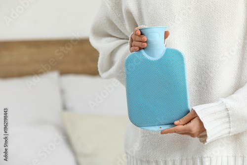 Woman with hot water bottle...