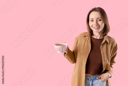 Young woman with cup of tea...