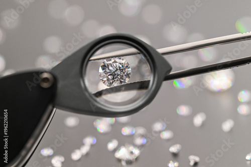 Jeweler examines flawless diamond through magnifying tool