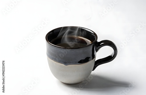 A steaming hot cup of coffee in a modern ceramic mug on a plain white background