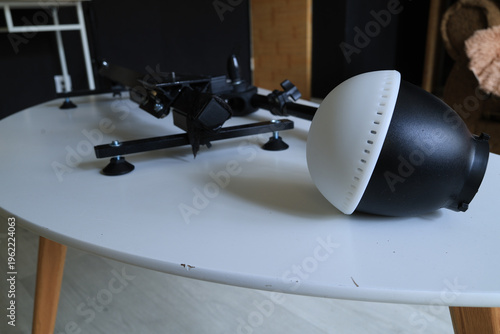 Close-up of a black and white photography light modifier on a white table