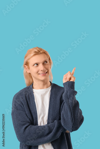 Young blonde man in cardiga...