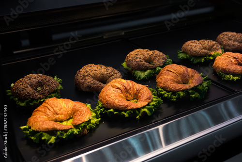 rye and wheat croissants with filling and salad on a store display