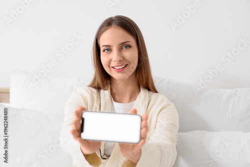 Young woman with blank mobi...