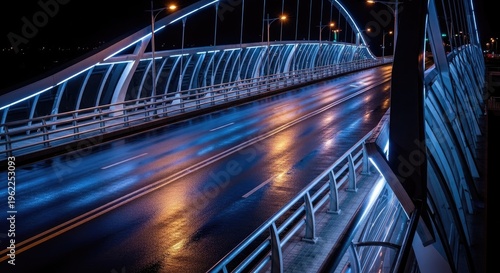 Modern bridge illuminated with blue lights reflecting on wet asphalt at night