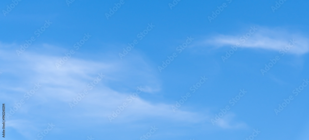 Fototapeta premium Low angle view and full frame of beautiful light blue sky with thin white clouds in the afternoon on sunny day used as natural background texture in decorative art work