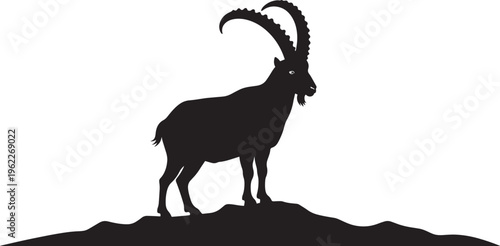 Silhouette of a goat standing on a hill
