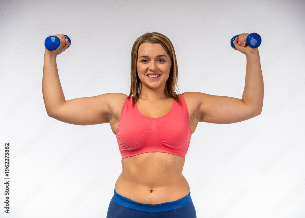 Fototapeta premium Woman Lifting Dumbbells Strong.