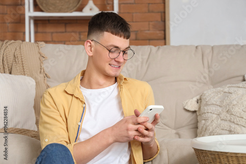 Young man using mobile phon...