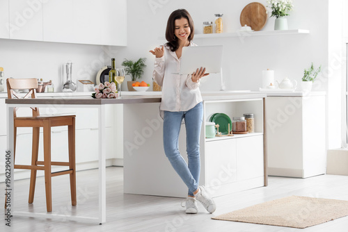 Young woman with laptop hav...