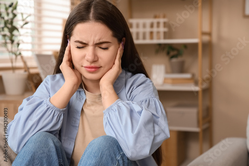 Young woman feeling pain in...