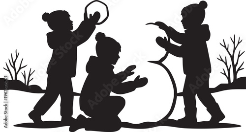 Joyful silhouettes of children building a snowman during winter playtime outdoors
