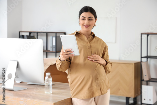 Pregnant businesswoman with...