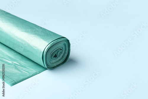 Roll of garbage bags on blu...