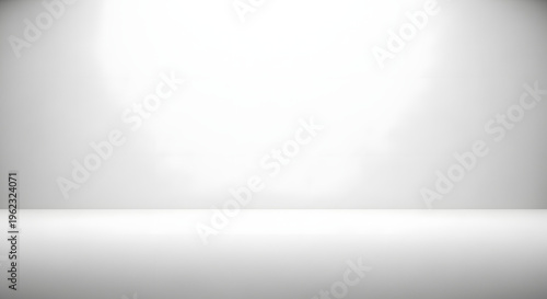A brightly lit empty white room with a subtle gradient effect
