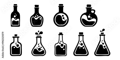 Various laboratory flasks and beakers with liquids are arranged on a table indoors.