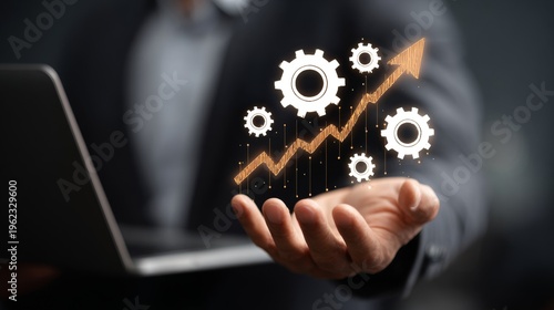 Businessman holding gear graph.