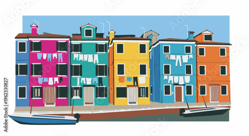 Colorful buildings line a canal with boats and drying laundry