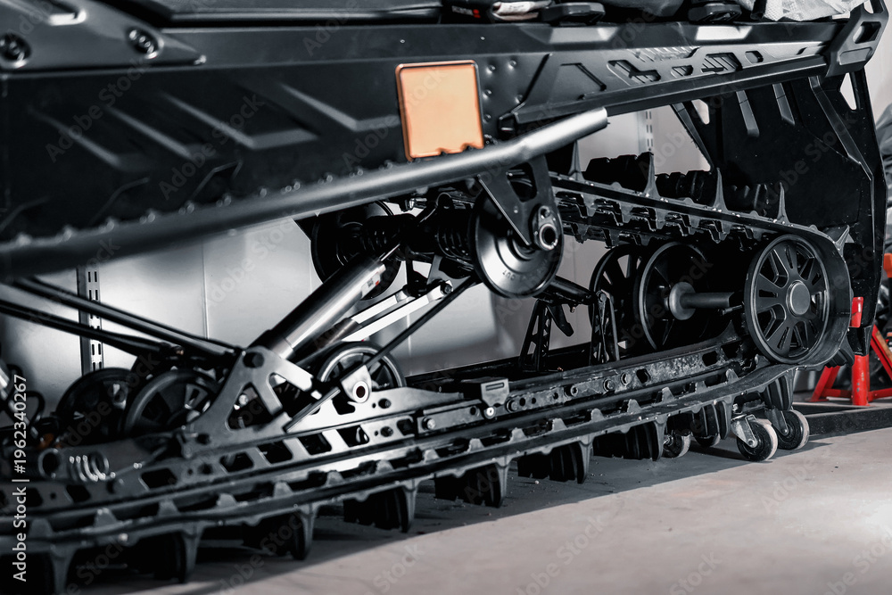 Obraz premium Snowmobile Track System and Suspension Wheels Close Up Winter Vehicle Mechanical Engineering