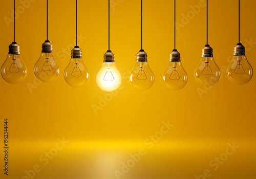 Eight hanging light bulbs with one glowing on yellow wall background