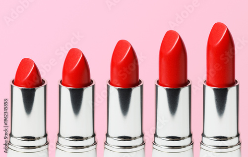 Red Lipsticks Against a Pink Background