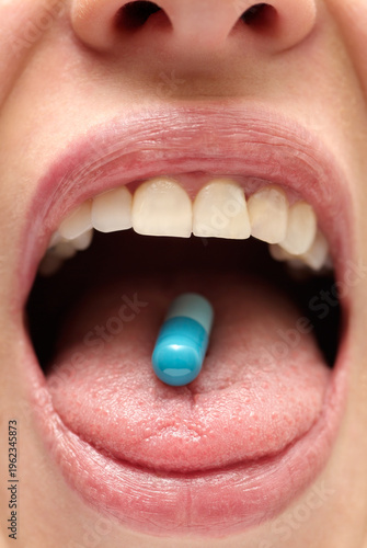 Young Woman Swallowing a Medicine Capsule, Close Up