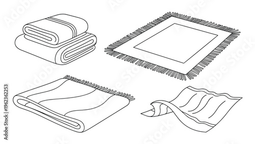 Assorted home textiles including folded cotton towels and various patterned rugs with decorative fringed edges displayed as a collection.