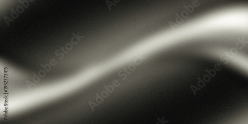 A close-up view of a sleek, white, wavy line on a dark background