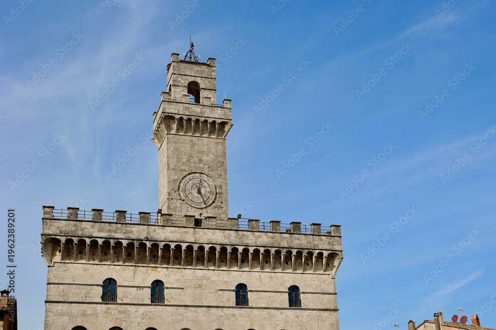 Fototapeta premium Palazzo Comunale Clock Tower in Montepulciano Against Blue Sky, Tuscany, Italy