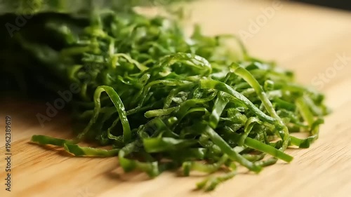 Chopped seaweed on wooden cutting board.