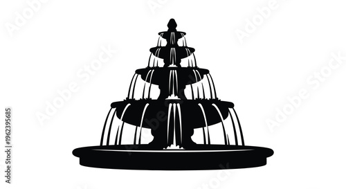 Silhouette of a large ornate fountain with water flowing from multiple tiers