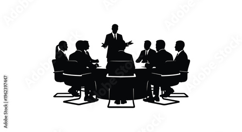 Silhouette of business team in meeting around a conference table with presenter