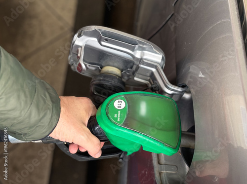 Quadro su tela Car refueling with E10 gasoline at petrol station close-up, Man pumping car tank with 95 octane petrol