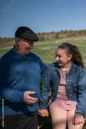 Grandfather and granddaughter sharing a happy outdoor moment