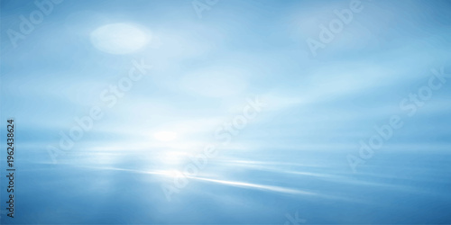 A beautiful summer day featuring the bright sun and white clouds reflecting over the blue sea water at the horizon during a peaceful sunrise nature landscape