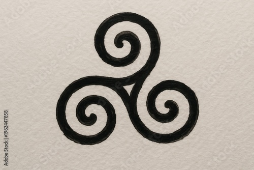 Triskelion spiral symbol hand drawn in bold black ink on textured paper