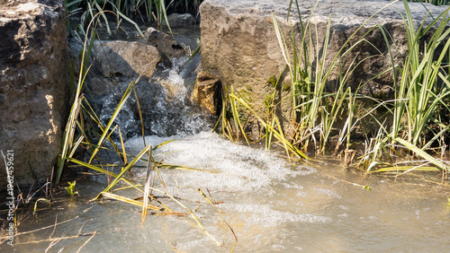 Small  stone threshold waterfall on the stream in Shofet Stream Nature Reserve near Yokneam city in northern Israel