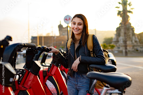 Woman renting a bicycle in the city. Electric bicycles. Rent a bike.