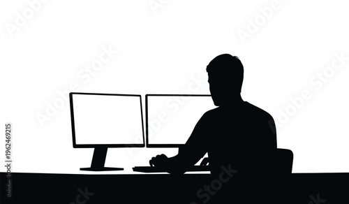 Silhouette of a person sitting in front of two computer monitors