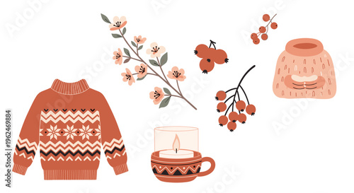 Collection of cozy winter and autumn items including a patterned sweater, a candle in a cup, various red berries, and a wool hat.