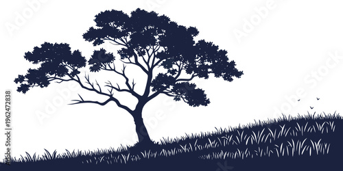 A majestic tree standing tall amidst a field of grass under a clear sky