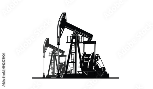 Silhouette of two oil pump jacks in operation at an oilfield